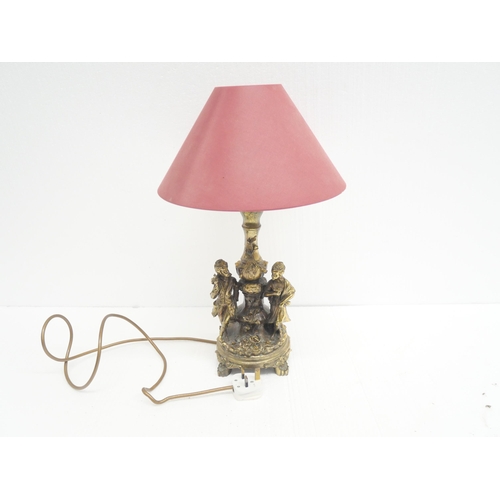 2283 - A gilt decorative figural table lamp depicting couple among floral decoration. Lamp shade included.