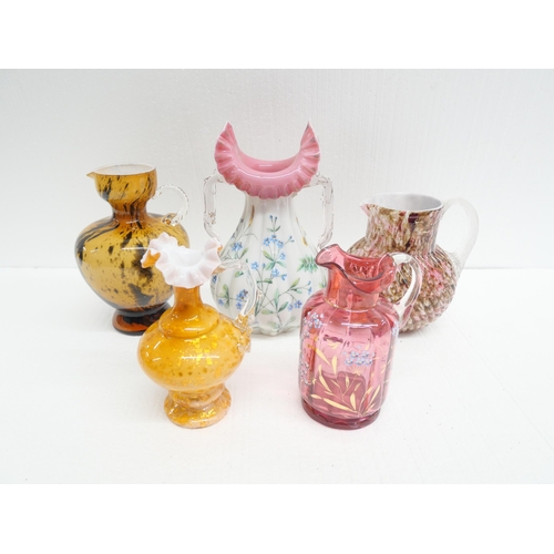 2284 - A collection of five coloured glass vases with some 19th Century blown glass examples. Having mottle... 