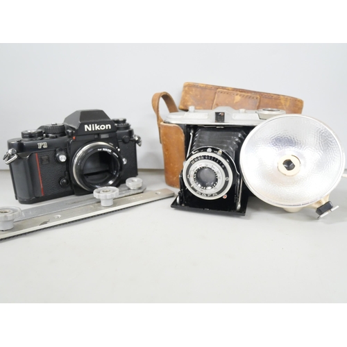 2299 - Two camera bodies, Nikon F3 and Agfa Isolette consisting camera with leather case and flash attachme... 