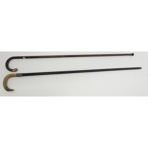 2308 - Two wooden walking sticks with silver trim, one with horn handle