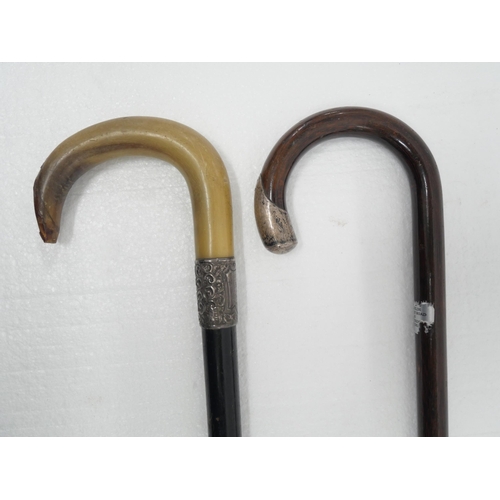 2308 - Two wooden walking sticks with silver trim, one with horn handle