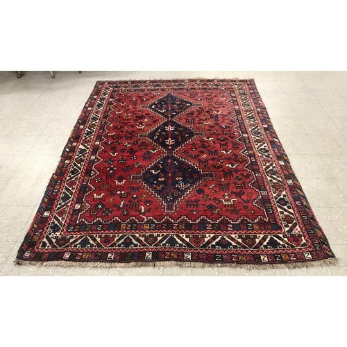 294 - An Eastern red ground rug, 265 x 185cms