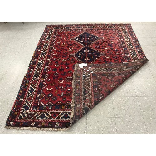 294 - An Eastern red ground rug, 265 x 185cms