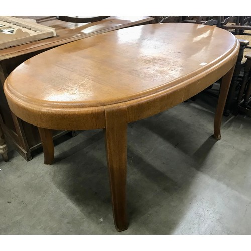 296 - An Art Deco oak oval dining table