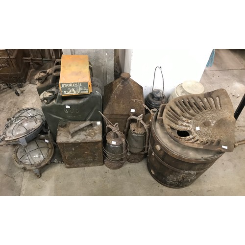 338 - Two jerry cans, three industrial light fittings, three oil lamps and a vintage tractor seat