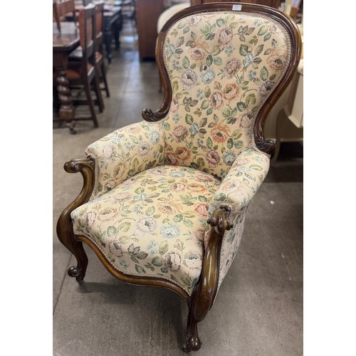 235 - A Victorian carved mahogany and fabric upholstered armchair