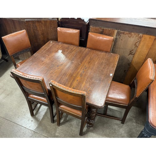 243 - An early 20th Century oak extending dining table and six barleytwist chairs