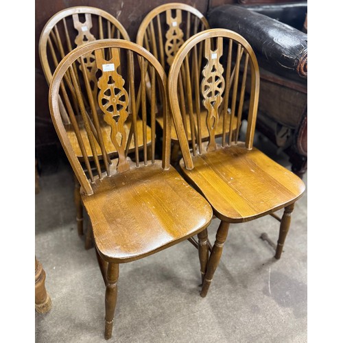 249 - A set of four early 20th Century beech wheelback kitchen chairs