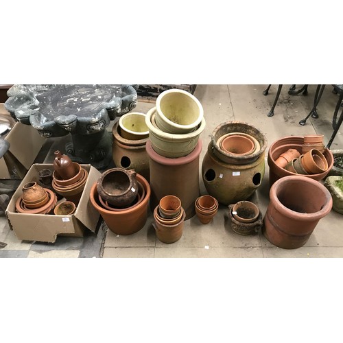 343 - A large quantity of terracotta planters, strawberry planters, chimney pots, etc.