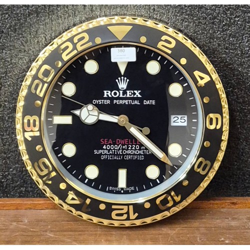 380 - A Rolex style dealers display wall clock