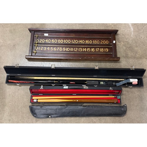 321 - Three cased snooker cues, including Riley and a scoreboard