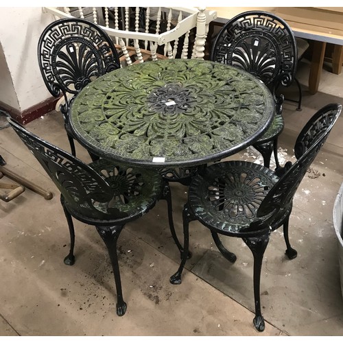 349 - A cast alloy garden table and four chairs