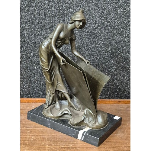 390 - An Art Nouveau style bronze figure of a lady with folio, on black marble socle