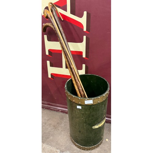 328 - A handpainted stickstand and a collection of walking sticks