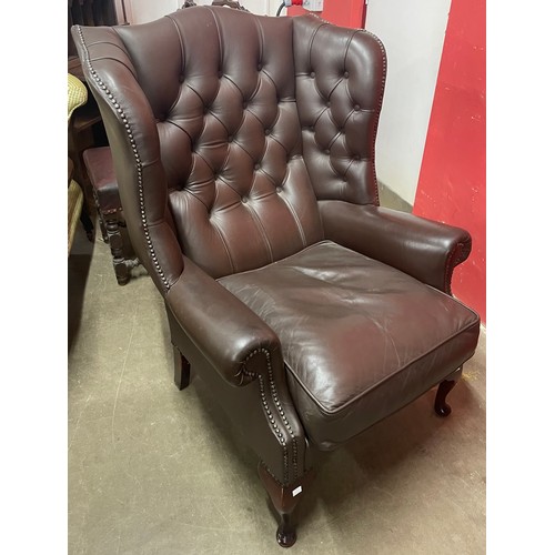 262A - A brown leather Chesterfield wingback armchair