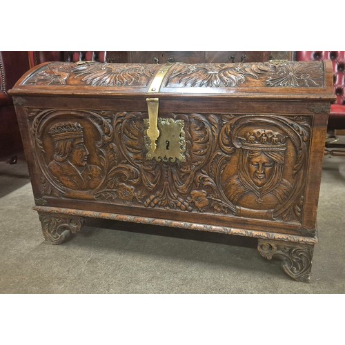 112 - An 19th century extensively carved armorial walnut dome topped trunk