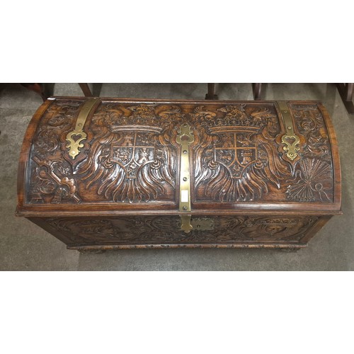 112 - An 19th Century extensively carved armorial walnut dome topped trunk