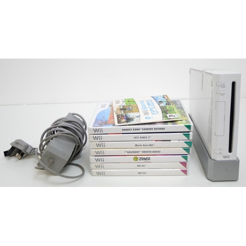 8001 - A Nintendo Wii with an assortment of accessories and games including Wii Fit board, steering wheel, ... 