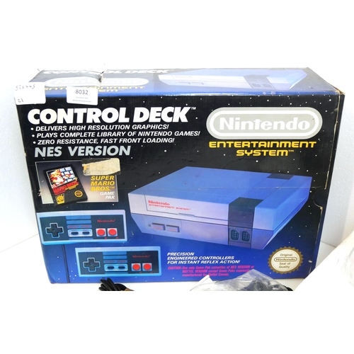 8032 - A boxed and complete Nintendo Entertainment System control deck with a complete in box copy of Super... 