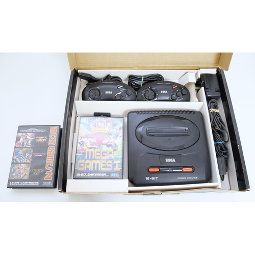 8043 - A boxed Sega Mega Drive II games console - complete with two control pads, two boxed games including... 