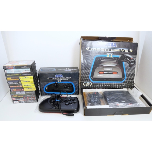 8046 - A boxed Sega Mega Drive II and a boxed Sega Mega Drive Arcade Power Stick II with a quantity of game... 