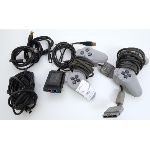 8050 - Two original PlayStation controllers (non-analog) and a quantity of assorted PlayStation cables incl... 