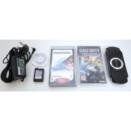 8058 - A Sony PSP with power cable and 3 games including F1 Grand Prix (loose), Ridge Racing, in case with ... 