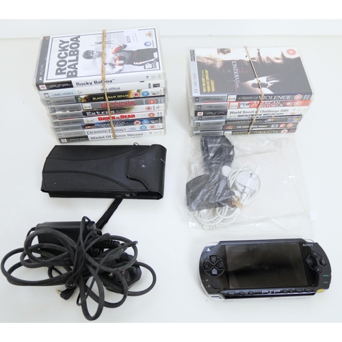 8059 - A PlayStation PSP1003 hand held console with 3 games 13 PSP DVD's, charger, wrist band case, earphon... 