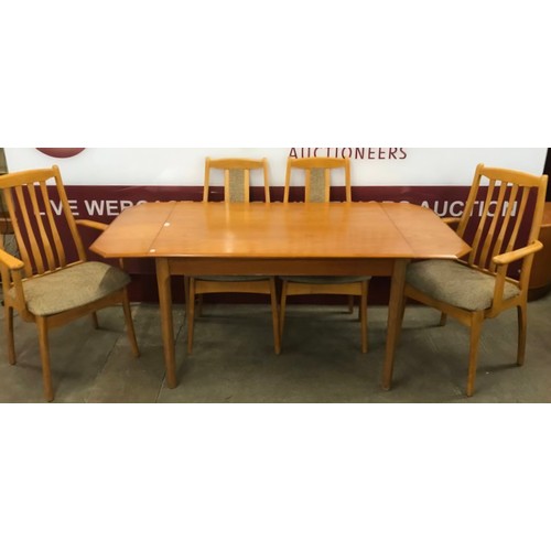 63 - A teak drop leaf table and four chairs