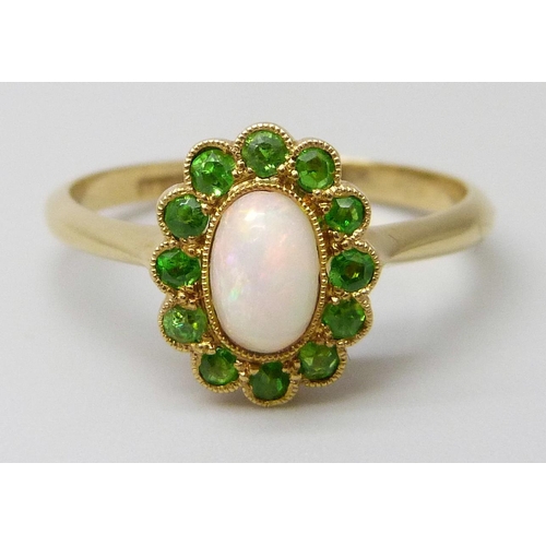 7027 - An early 20th Century 18ct yellow gold halo ring set with Demantoid garnets and an opal, 2.3g, M