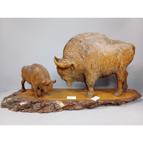 2010 - A large carved wooden figure of two European Bison on trunk base, possibly Polish, base 63cm