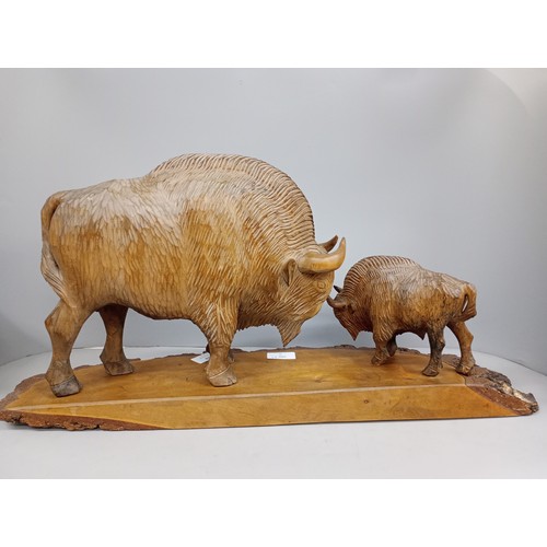 2010 - A large carved wooden figure of two European Bison on trunk base, possibly Polish, base 63cm