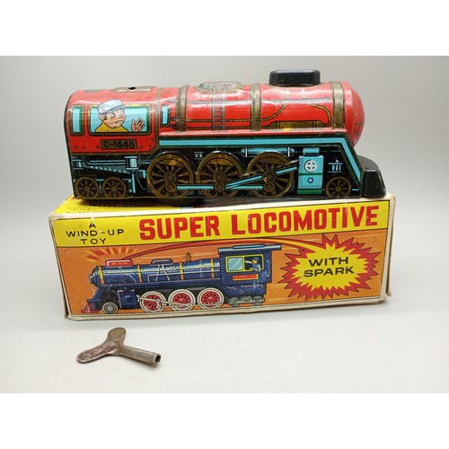 2020 - A tin-plate and plastic wind-up toy Super Locomotive with spark, Yone, made in Japan, in original bo... 