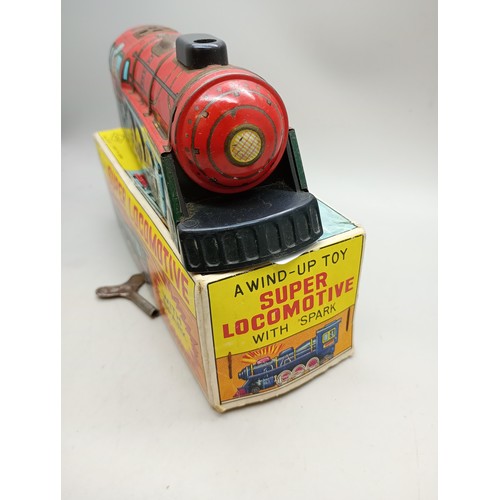 2020 - A tin-plate and plastic wind-up toy Super Locomotive with spark, Yone, made in Japan, in original bo... 