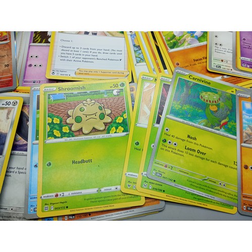 2022 - A large collection of Pokémon cards in collectors tin including holographic