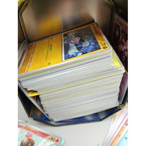 2022 - A large collection of Pokémon cards in collectors tin including holographic