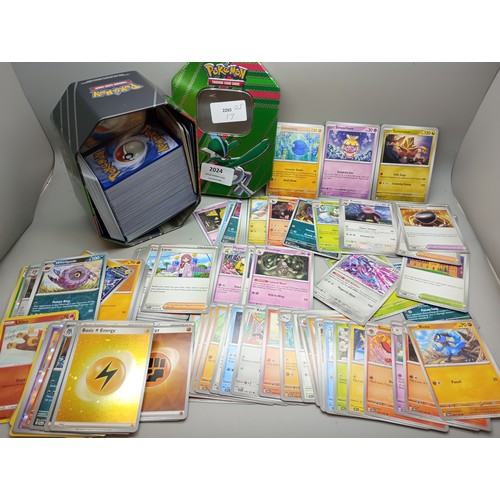 2024 - A large collection of Pokémon cards in collectors tin including holographic