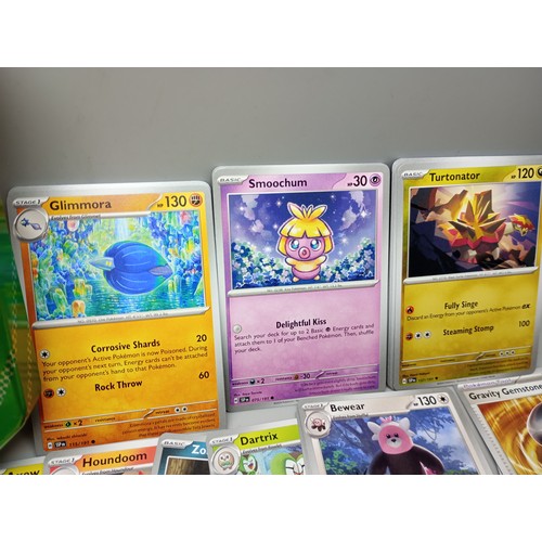 2024 - A large collection of Pokémon cards in collectors tin including holographic