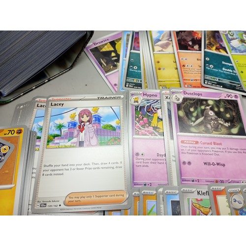 2024 - A large collection of Pokémon cards in collectors tin including holographic