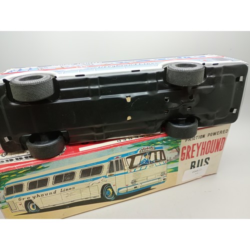 2033 - A Japan made friction powered tin-plate Greyhound coach, in original box, 25cm