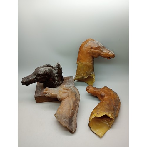 2034 - A bronze model horse head on a wooden base, 11cm, with three moulds