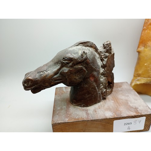 2034 - A bronze model horse head on a wooden base, 11cm, with three moulds