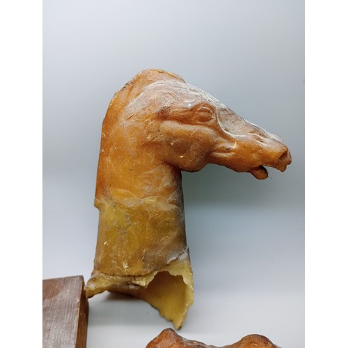 2034 - A bronze model horse head on a wooden base, 11cm, with three moulds