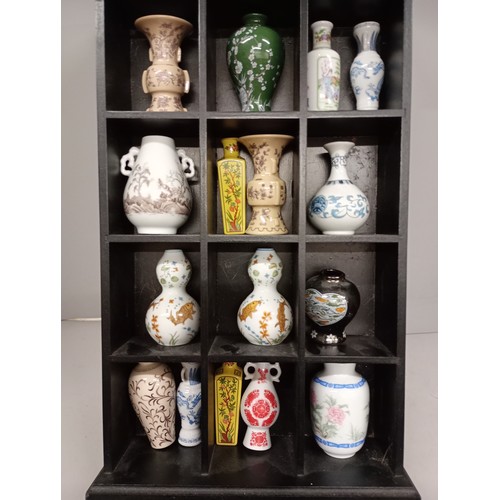 2052 - A collection sixteen of Franklin Oriental vases including Japan and Taiwan, with display rack