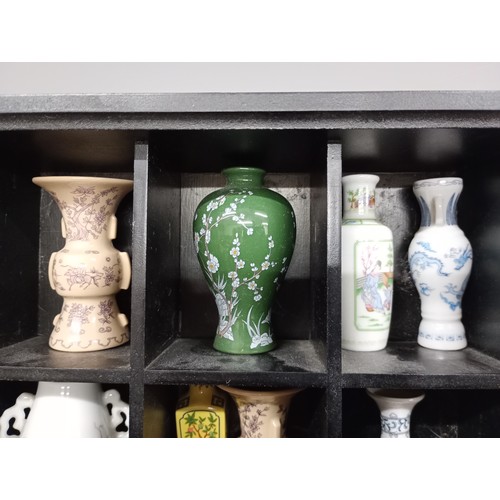 2052 - A collection sixteen of Franklin Oriental vases including Japan and Taiwan, with display rack