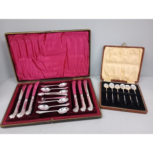 2058 - A cased breakfast set comprising six tea spoons, sugar bows and six pistol grip butter knives, also ... 