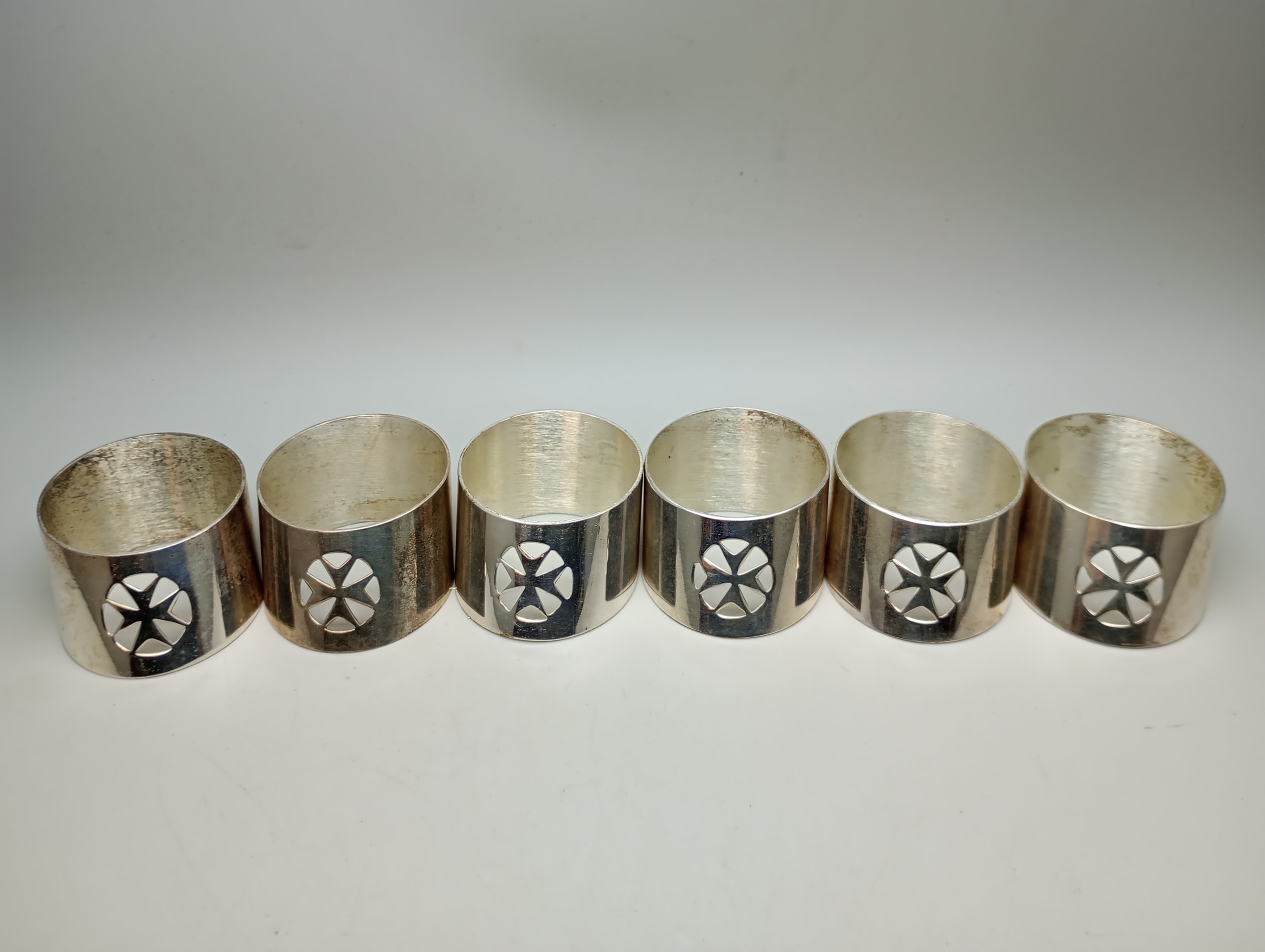 A set of Maltese cross napkin rings