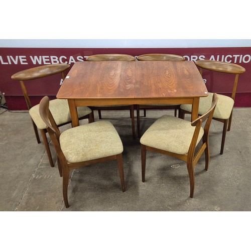 27 - A teak rectangular extending dining table and six chairs