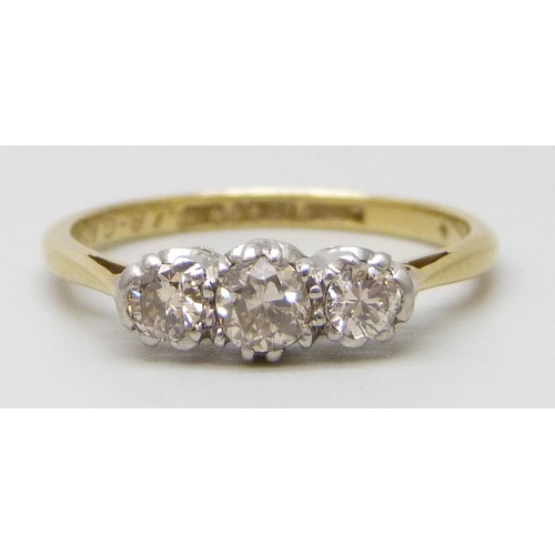 7017 - An 18ct gold and platinum diamond set trilogy ring, wit inscription dated 1939, 2.1g, L