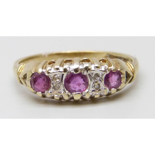 7043 - A 9ct gold ring set with rubies and diamonds, 1.9g, O